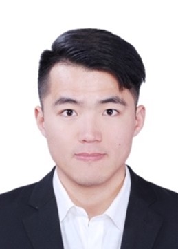 A person wearing a suit and tie smiling at the camera
Description automatically generated